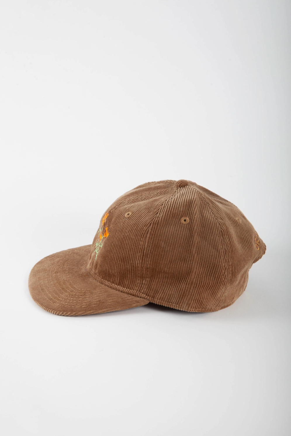 Brown corduroy cap on a white background