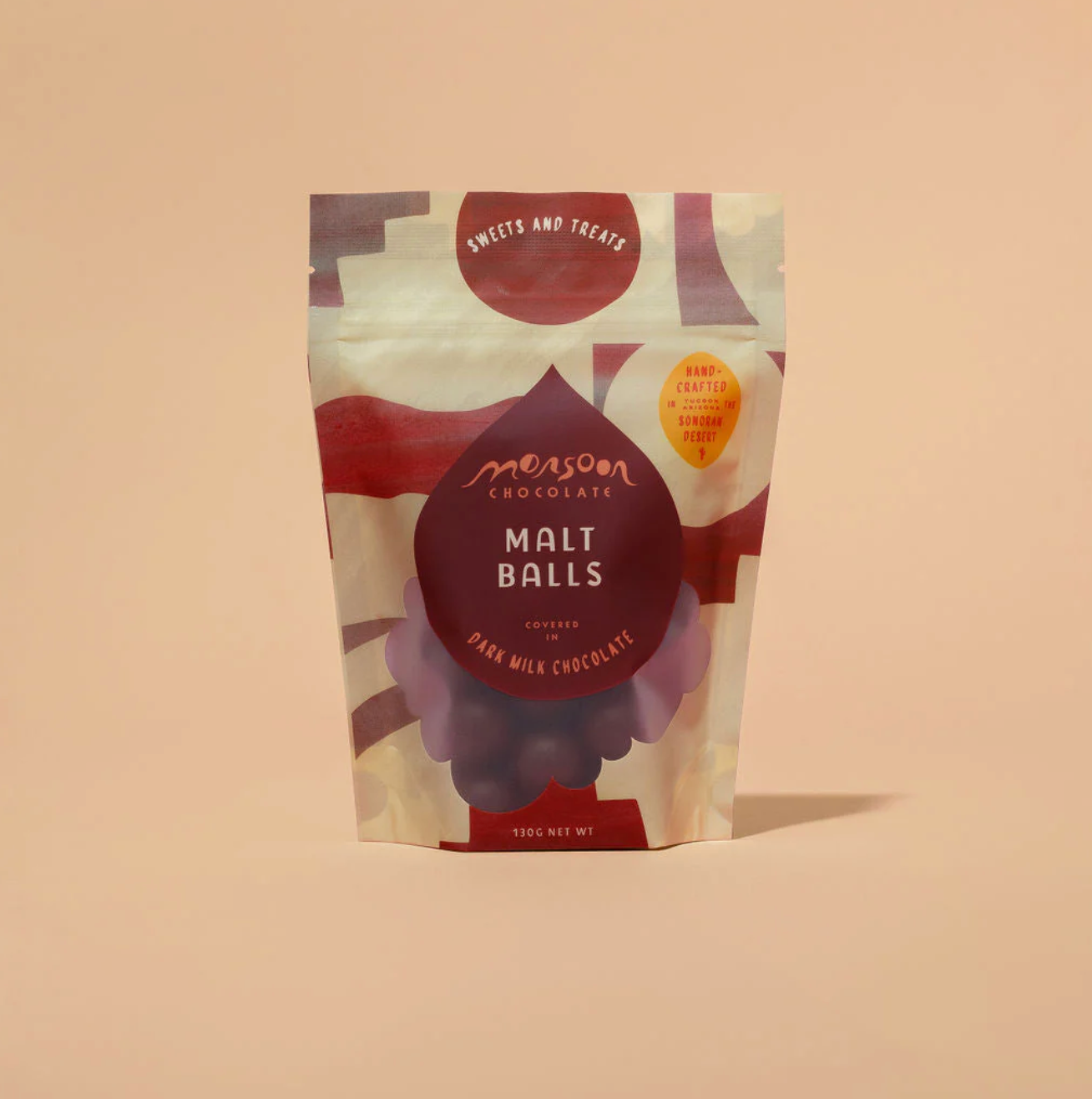 Packaging of Monson Chocolate Malt Balls on a beige background