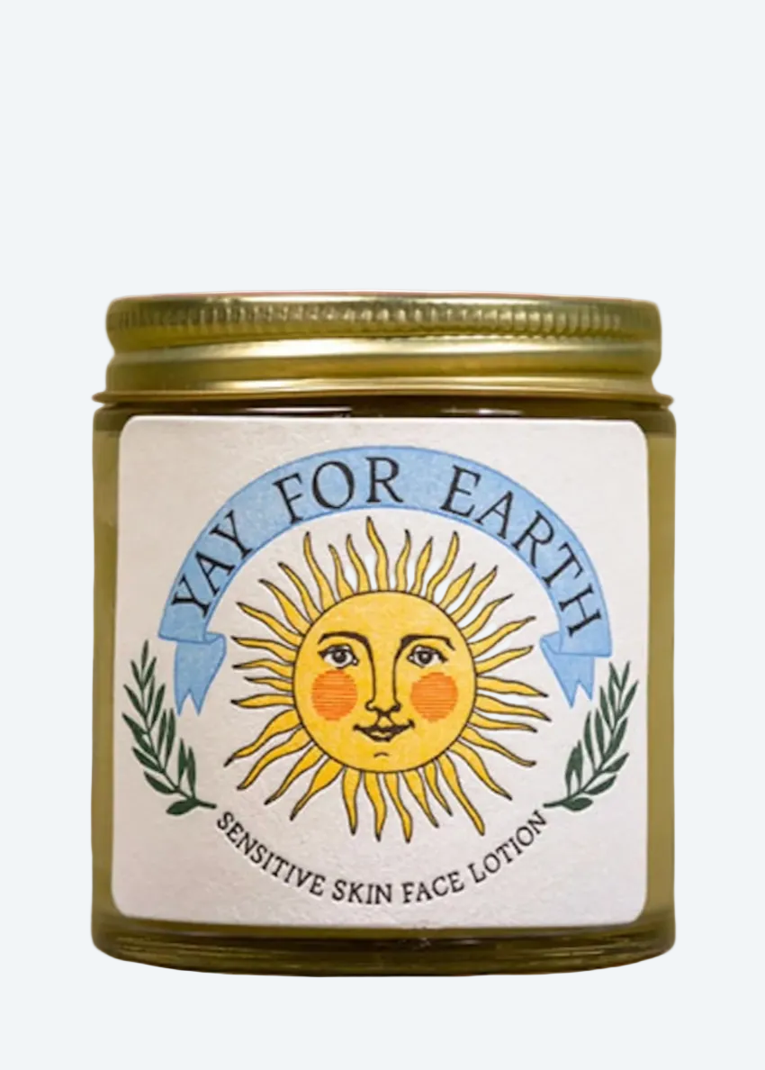 Jar of 'Yay for Earth' sensitive skin face lotion with a sun design on the label.
