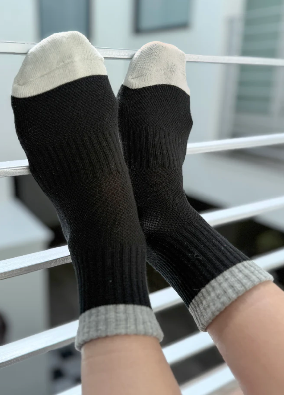 Black socks with gray cuffs and toes on a blurred background