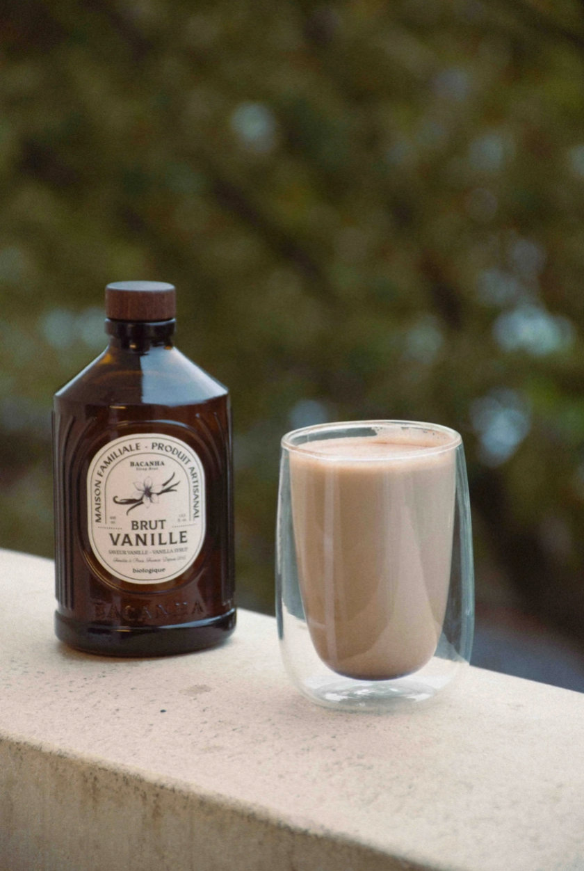outdoor photo of brown bottle with a glass of hot milk