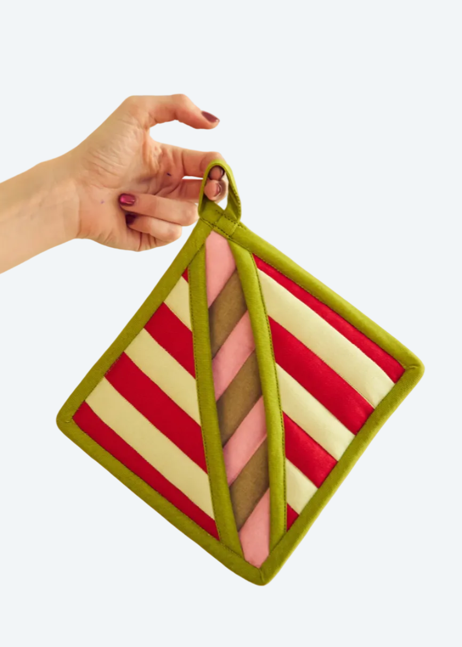 person holding striped potholder