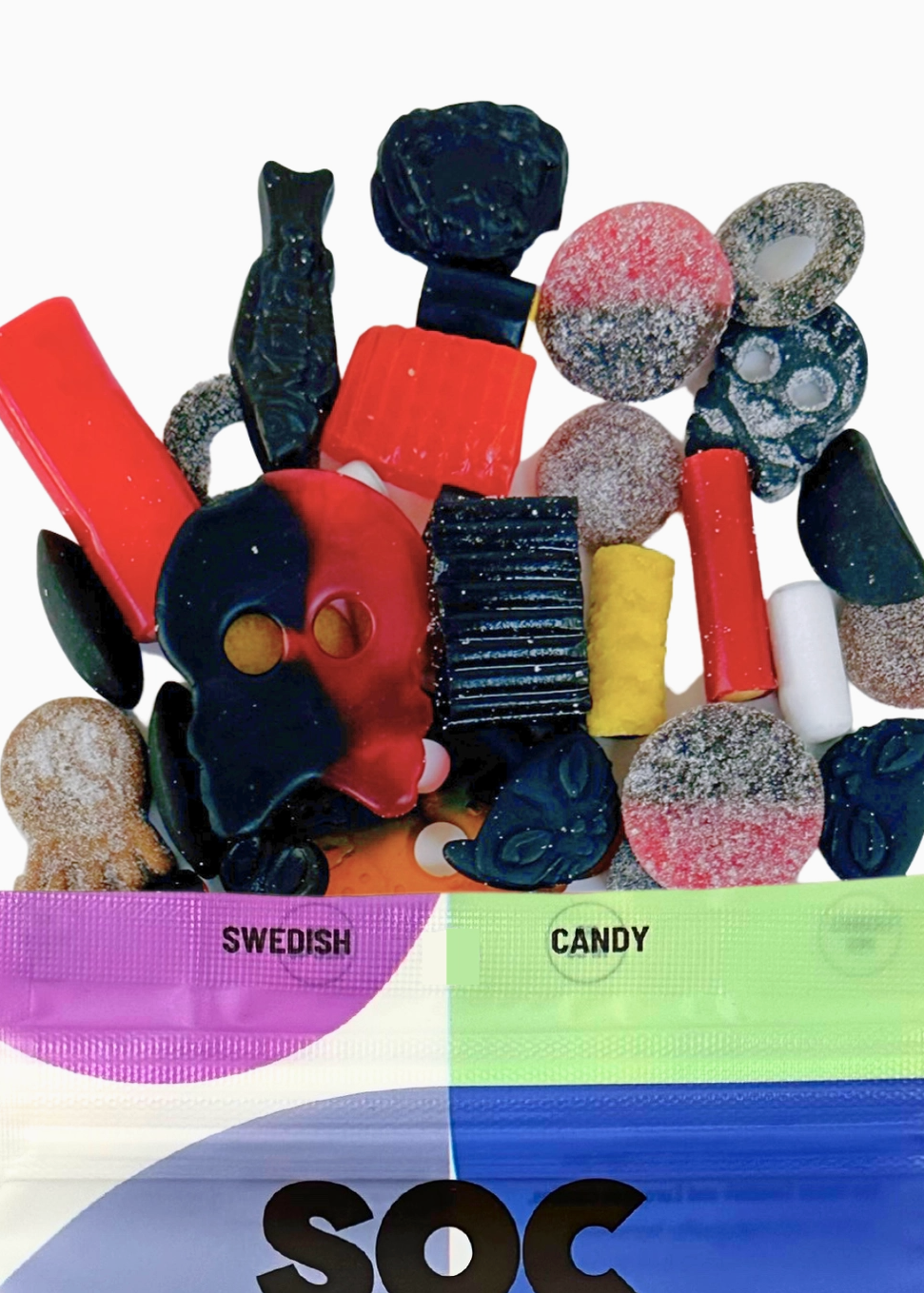 A pile of assorted Swedish candy pieces spilling out of a clear plastic bag with a colorful label that reads 'SWEDISH CANDY' and 'SOC' at the bottom, on a plain white background.