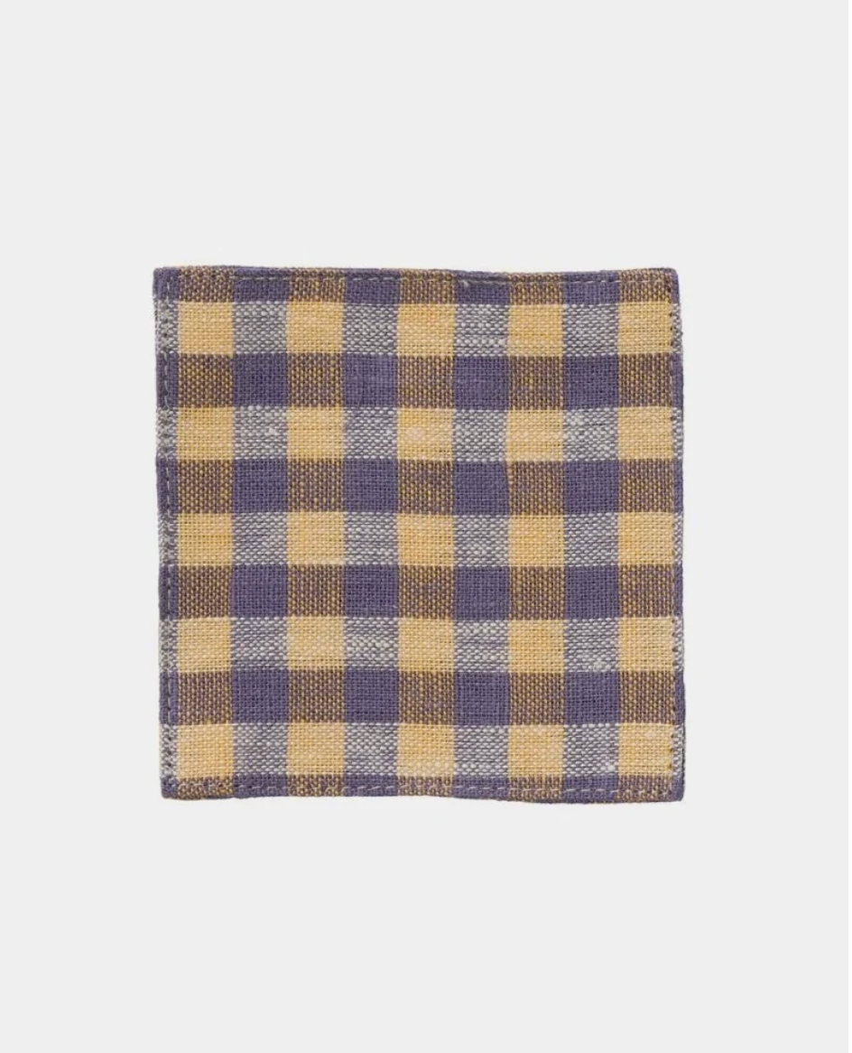 A square woven textile with a plaid pattern in beige and muted purple, shown flat against a light gray background.