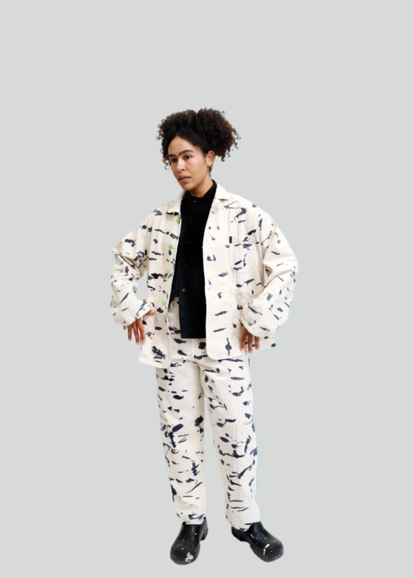 A model wearing a matching two-piece suit with a black and white abstract pattern