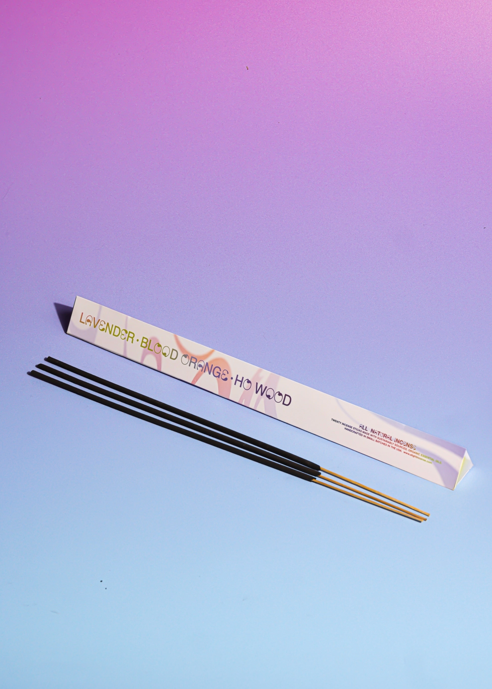3 sticks of incense and packaging on a purple blue background