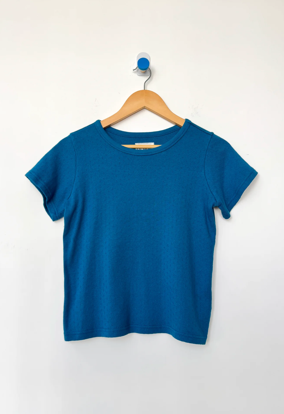 blue tee on hook flat lay