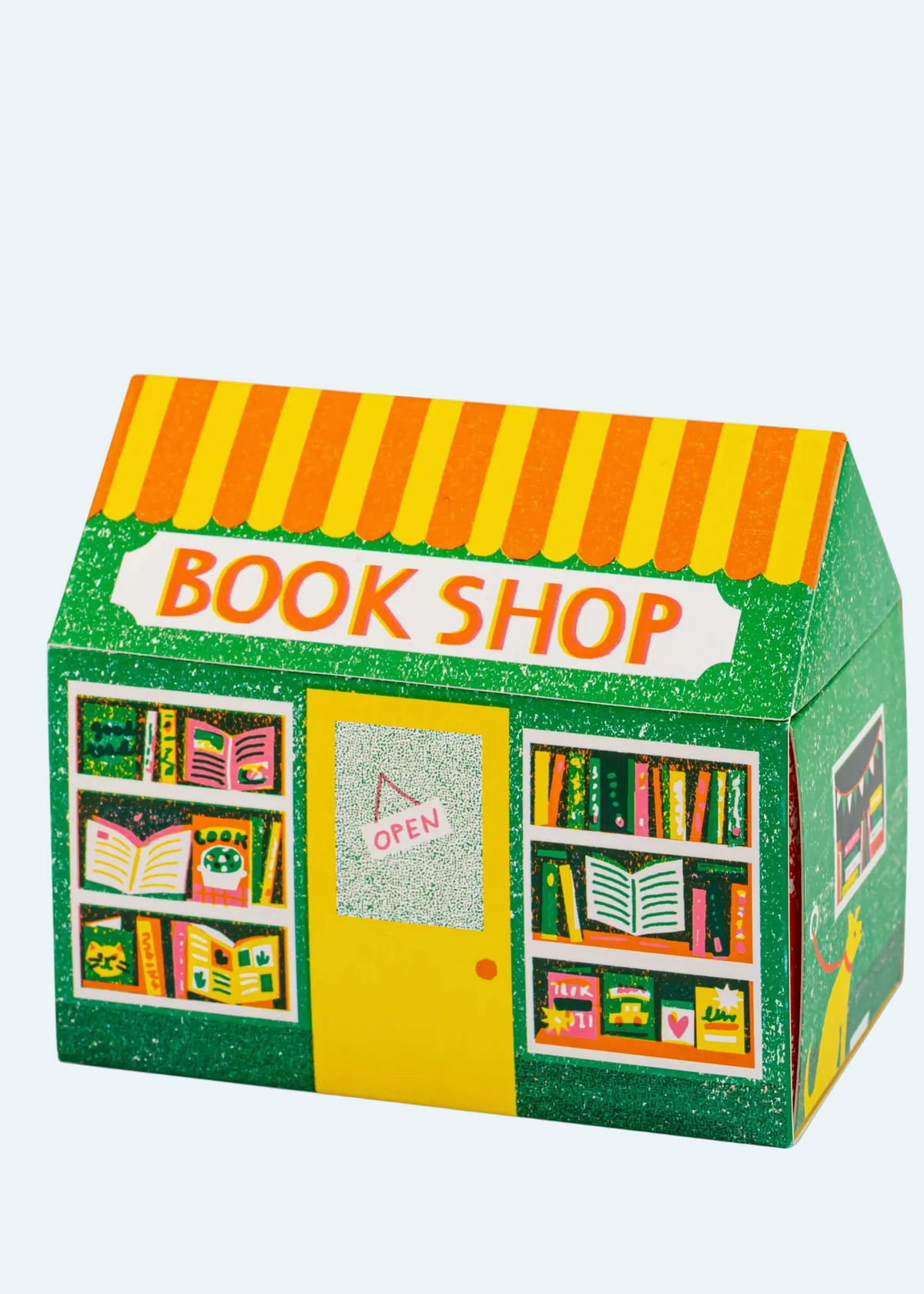 A 3D box mockup of a house-shaped book shop, featuring a green glittery exterior, yellow and orange striped awning, a yellow door with an 'OPEN' sign, and colorful book illustrations on the windows.