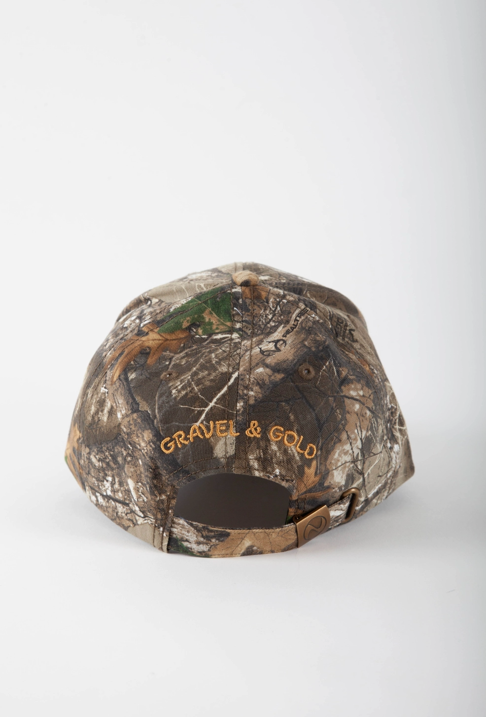 back of camo hat with gravel and gold written in brown/yellow