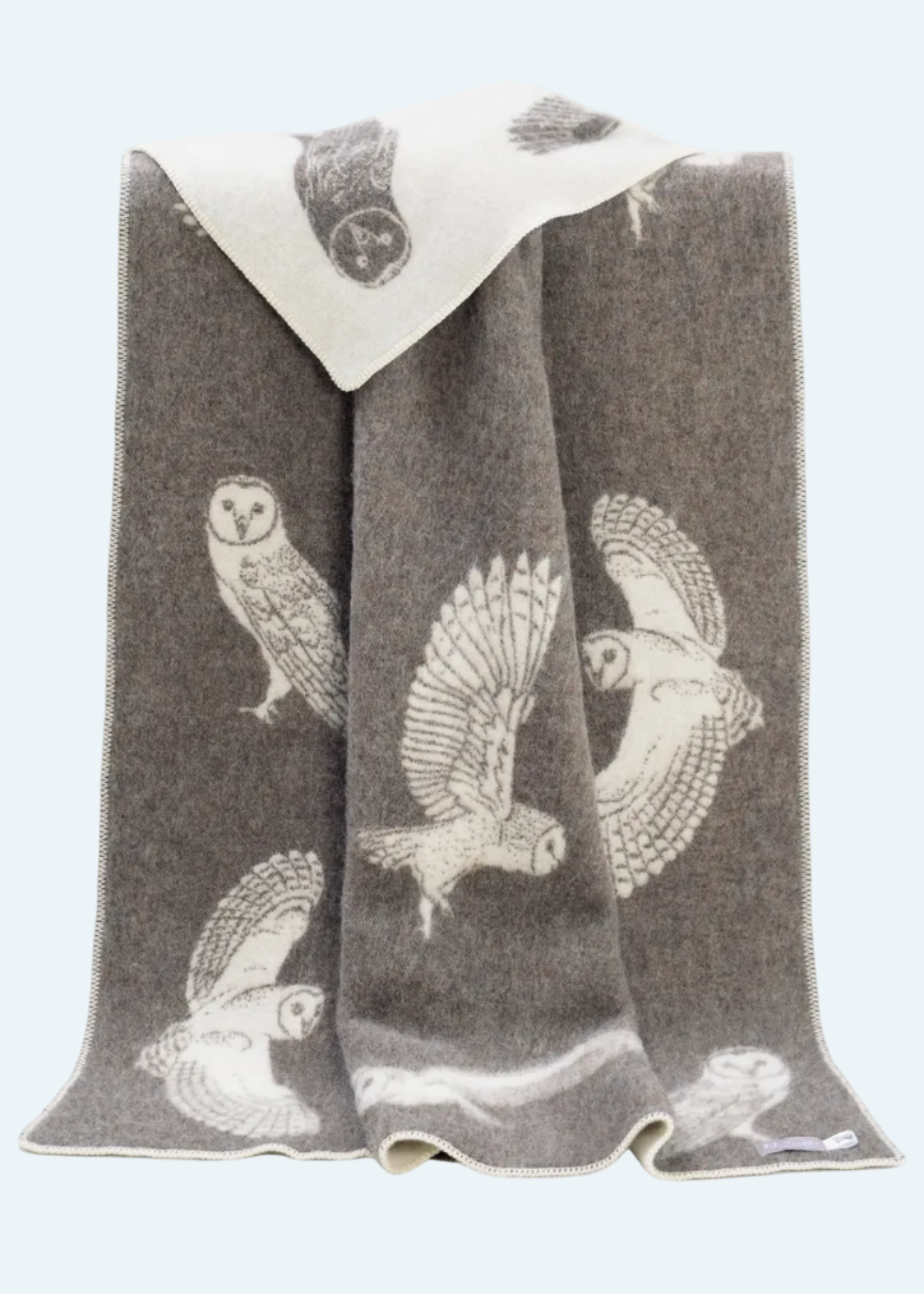 brown blanket with white owl