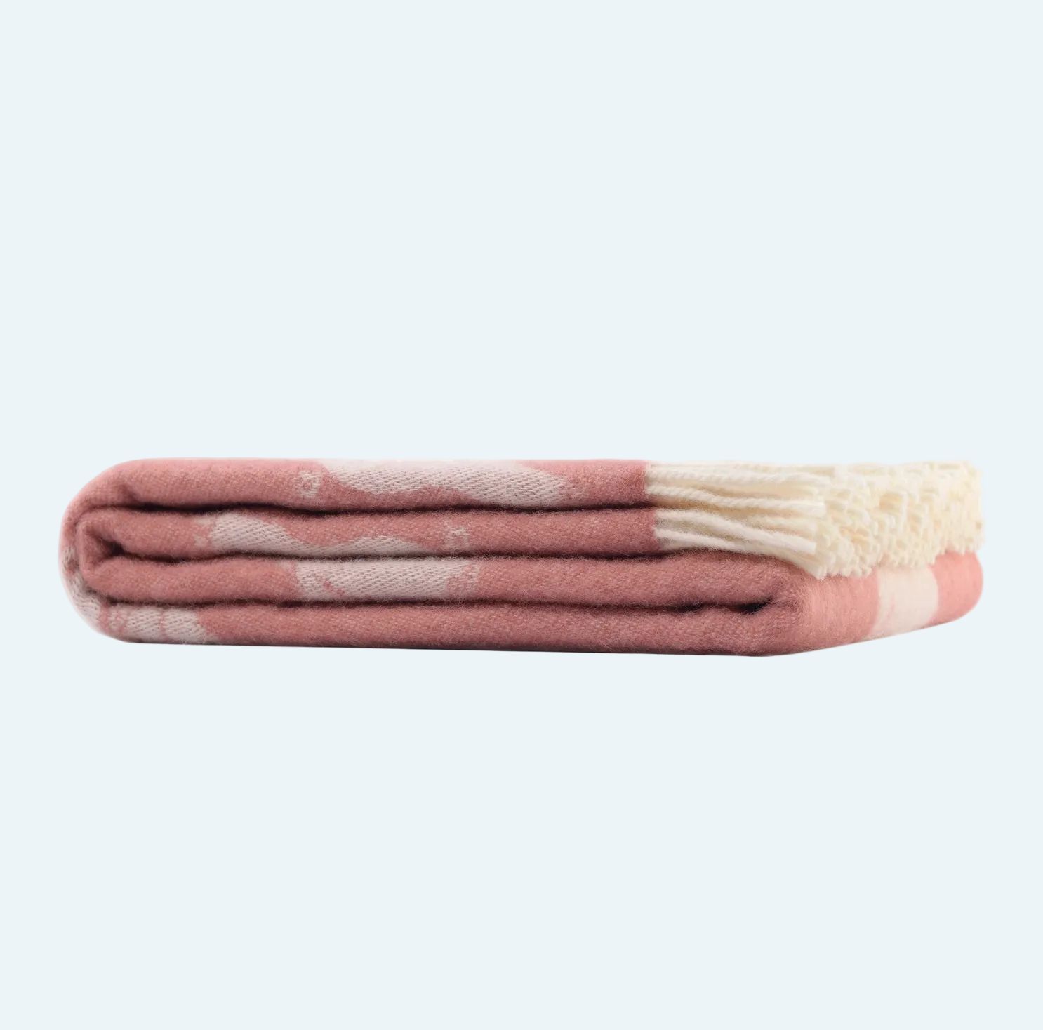 pink blanket with piglet design and white fringe folded