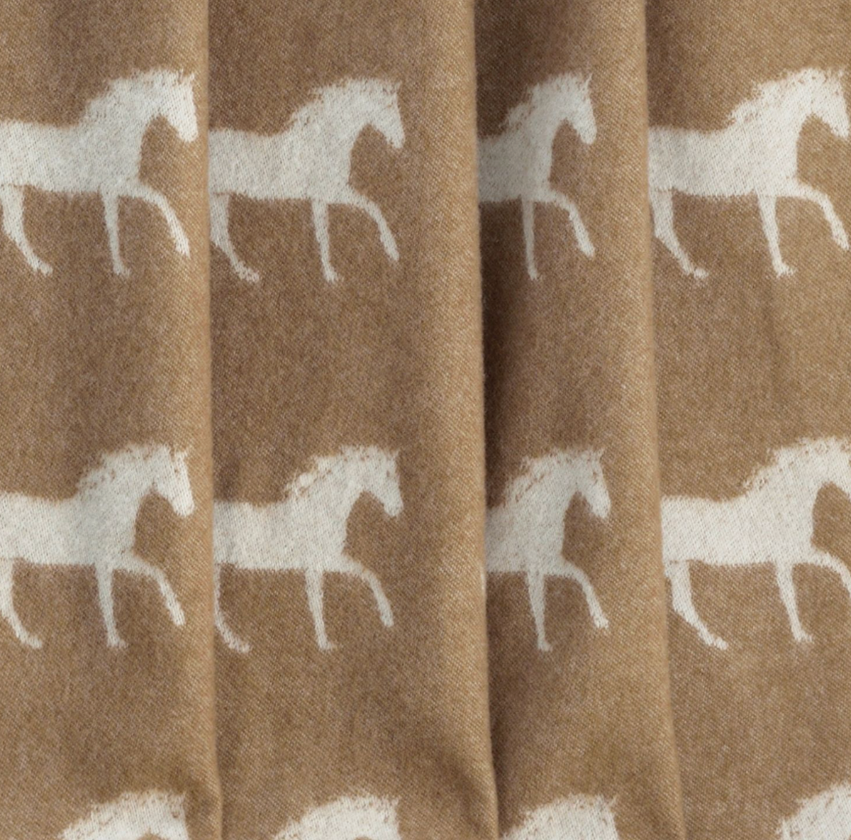 close up of brown blanket with horses