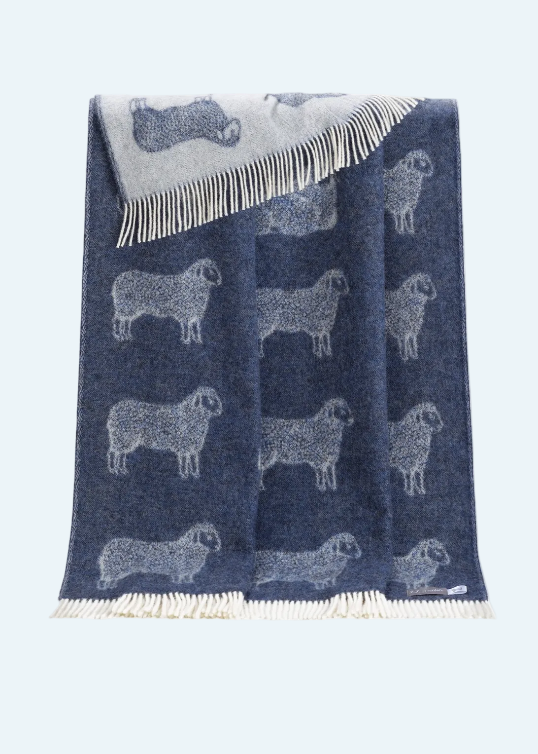 dark blue blanket with fringe and sheep design
