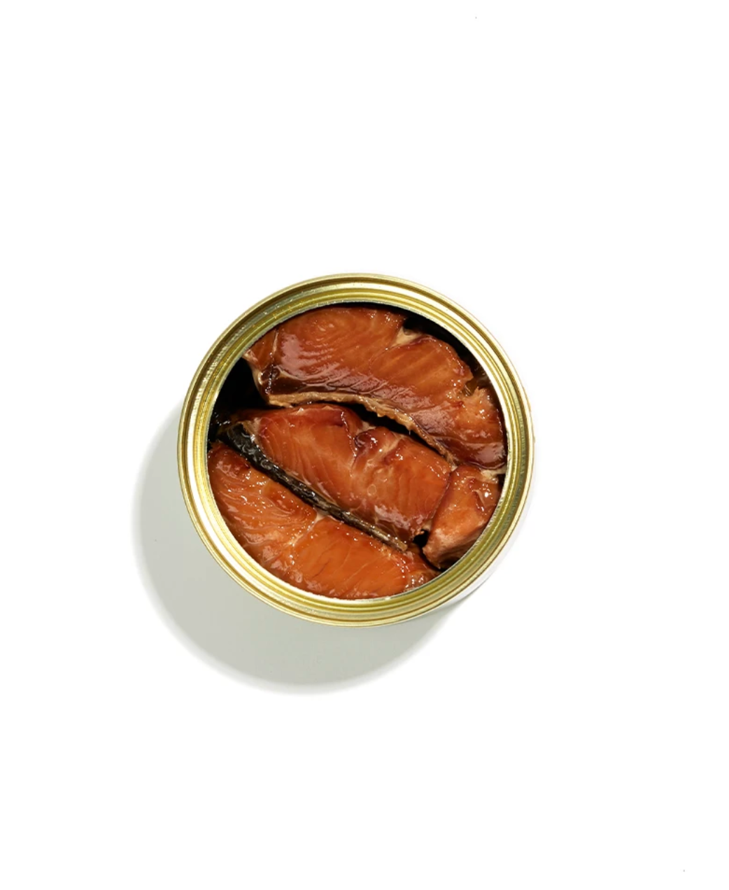 An open can of salmon fillets, viewed from directly above on a clean white background.