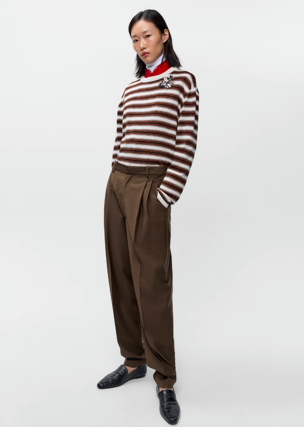 brown, black and white striped long sleeve t shirt on model with brown pants