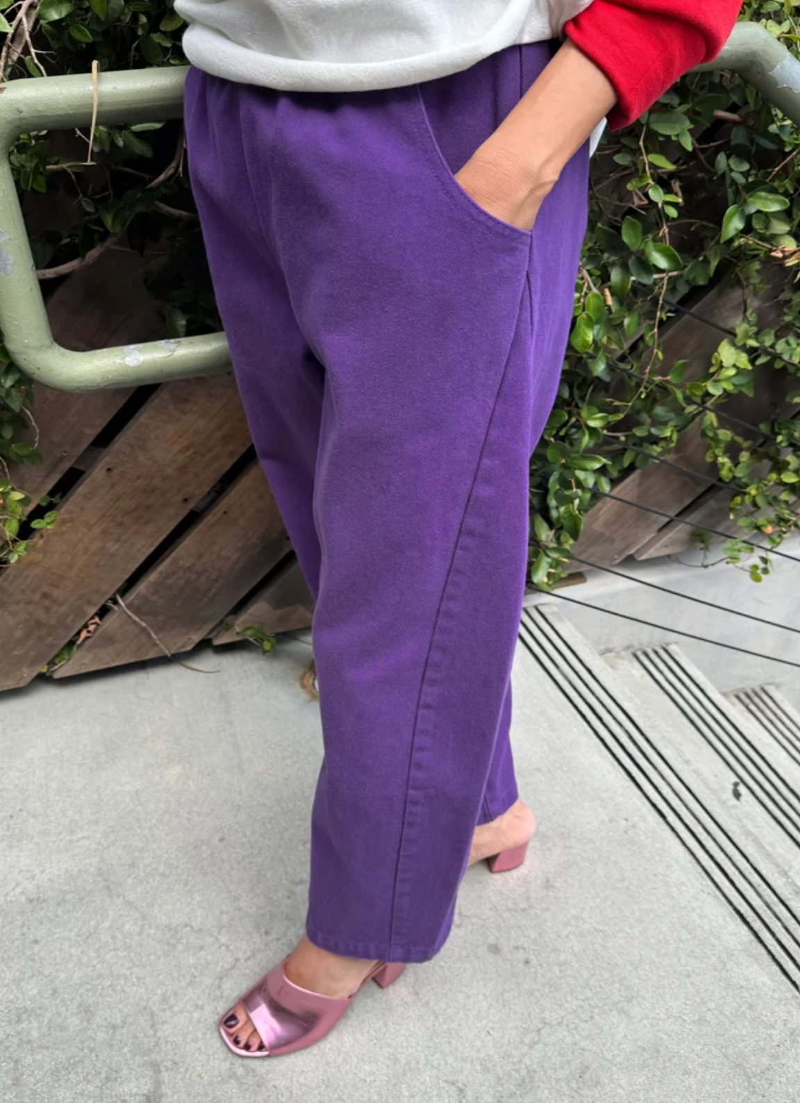 model wearing purple pants with purple high heels