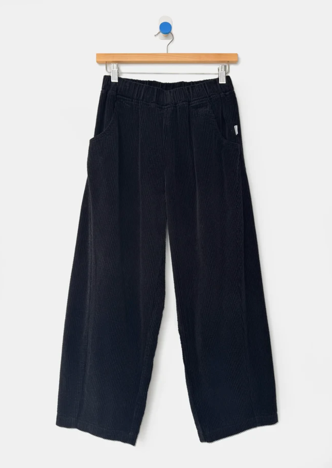 black cords hanging from wooden hanger