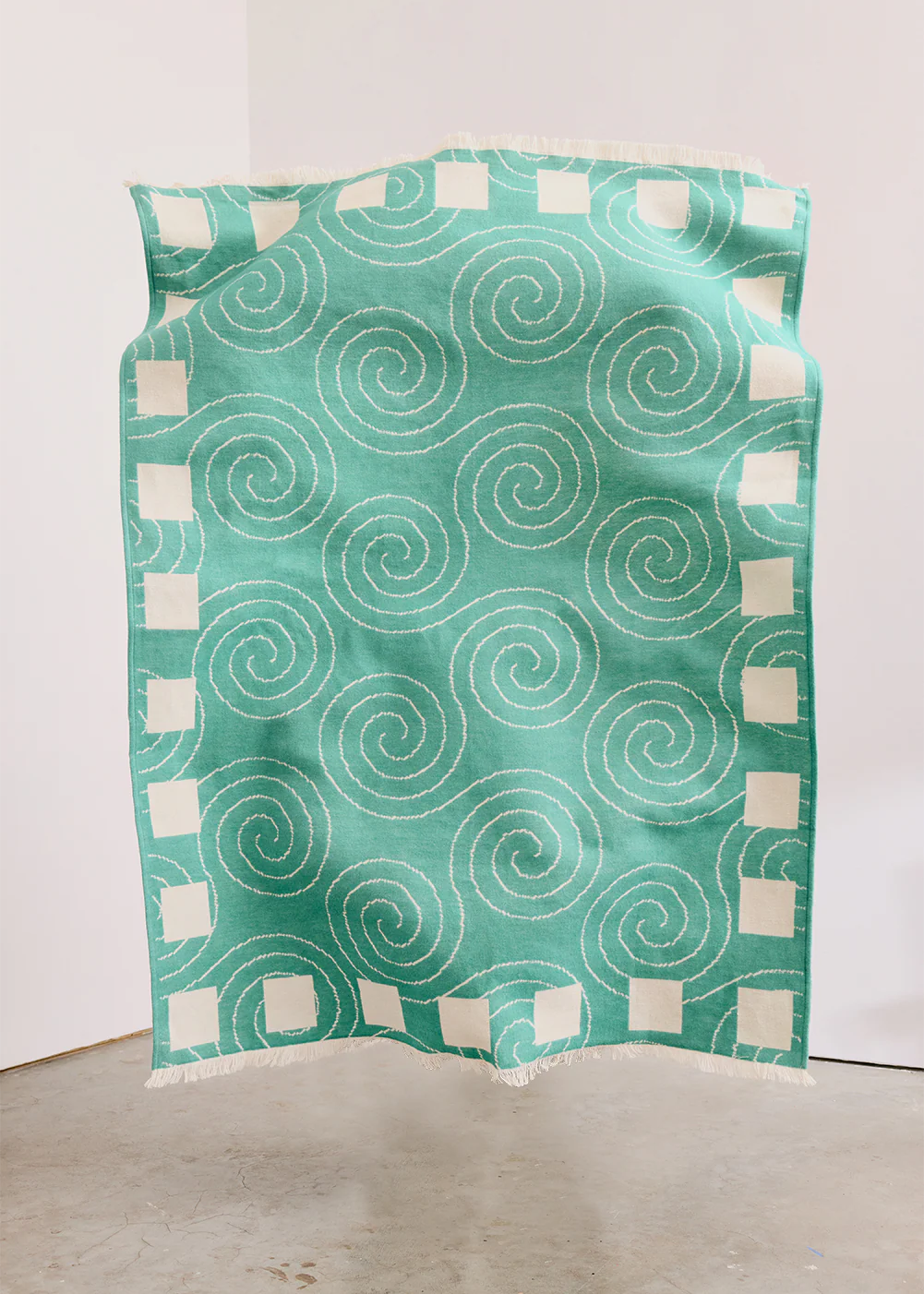 Green and white patterned fabric on a white background