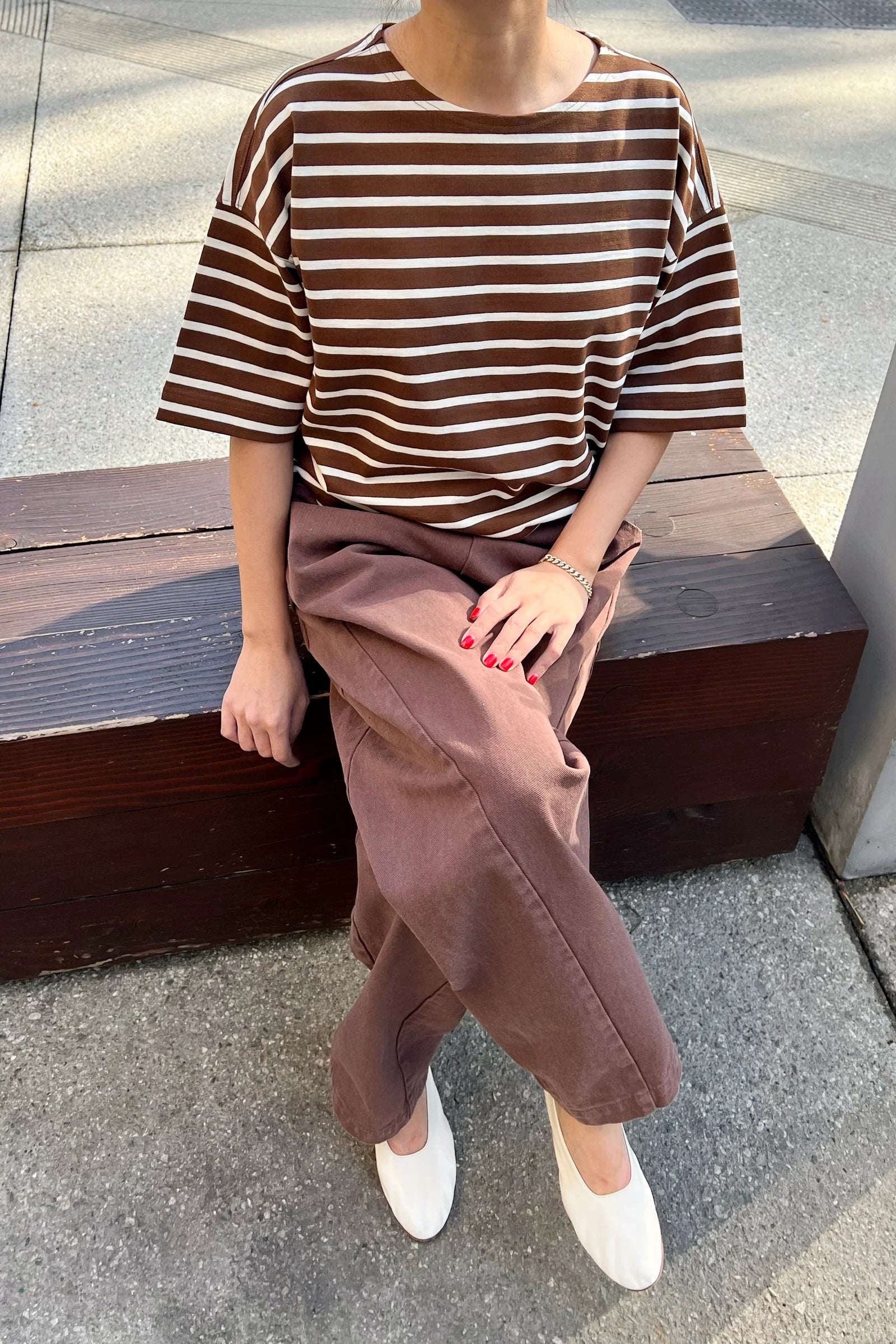 person wearing brown and white striped t shirt and brown pants