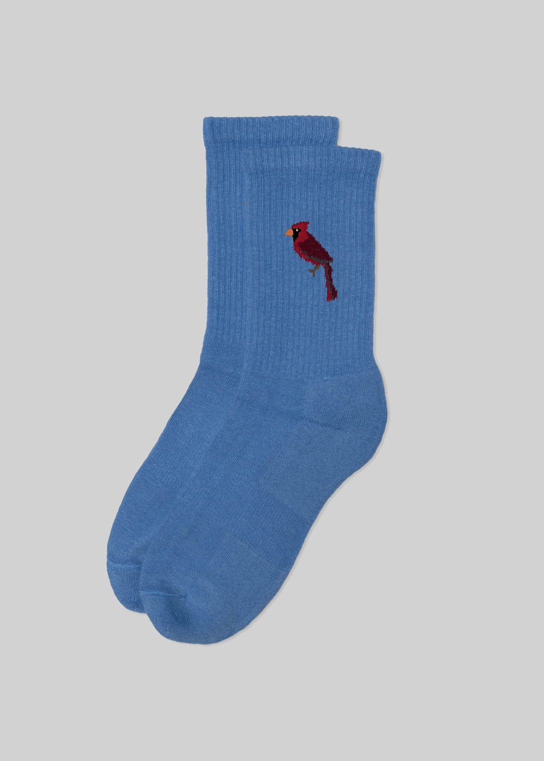 Blue sock with a red bird design on a light gray background