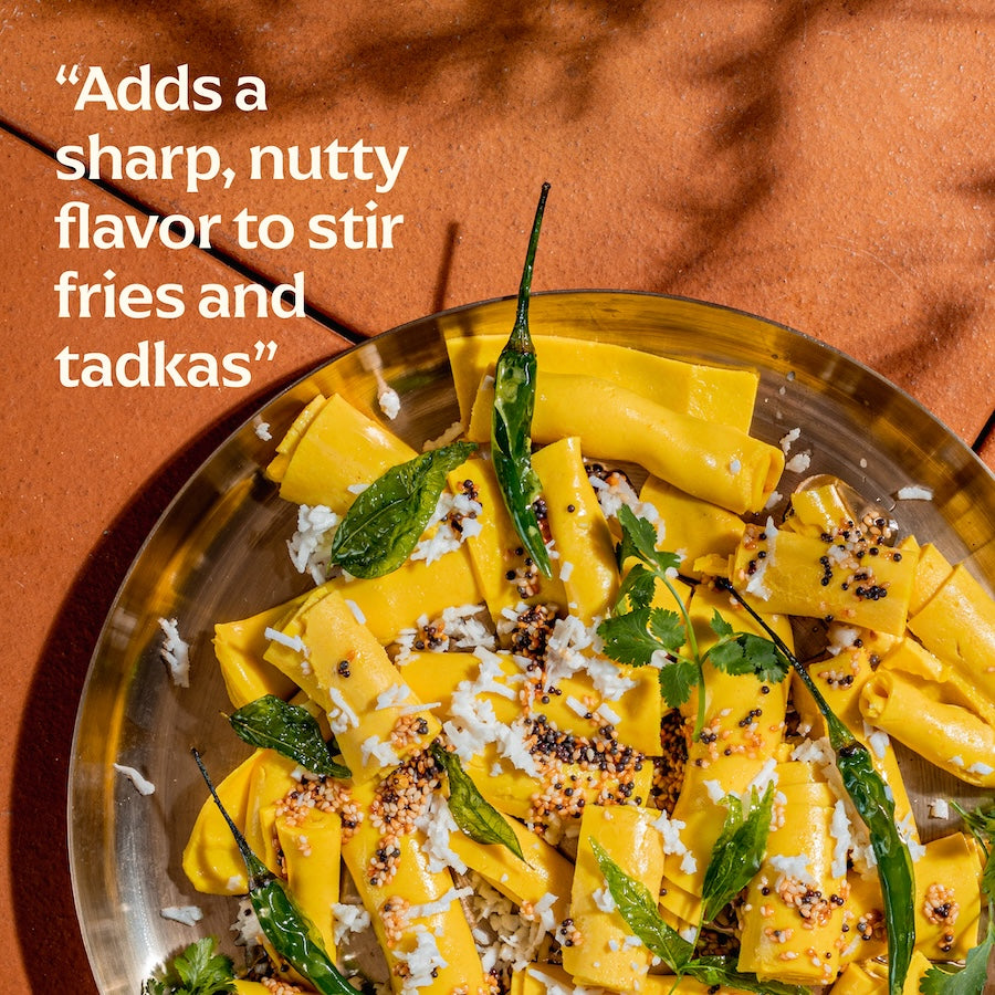 Plated dish of yellow food with garnishes on a brown background