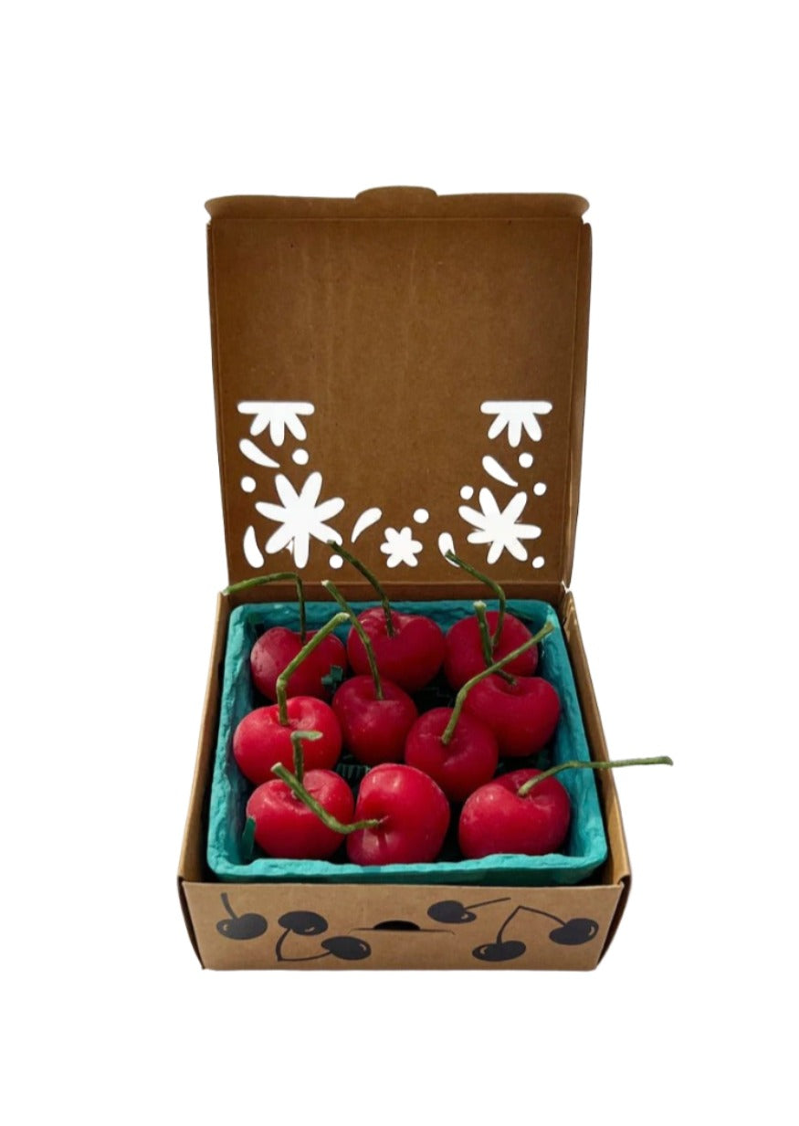 cherry shaped candles in produce box