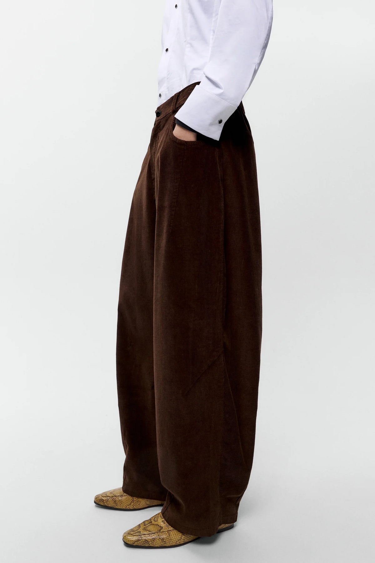 Brown wide-leg pants worn by a person on a white background