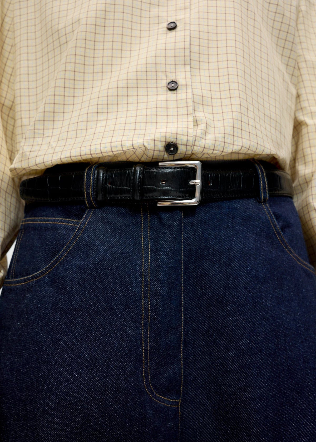 black belt on model wearing dark jeans and button up shirt