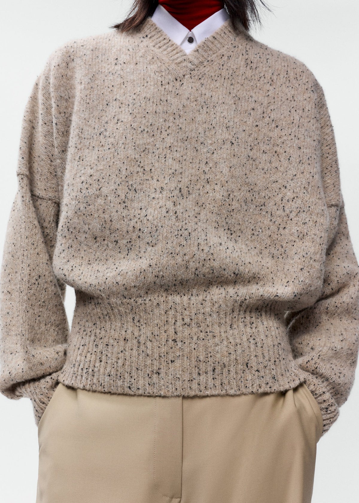 speckled tan v neck sweater with bat wing sleeves and banded waist