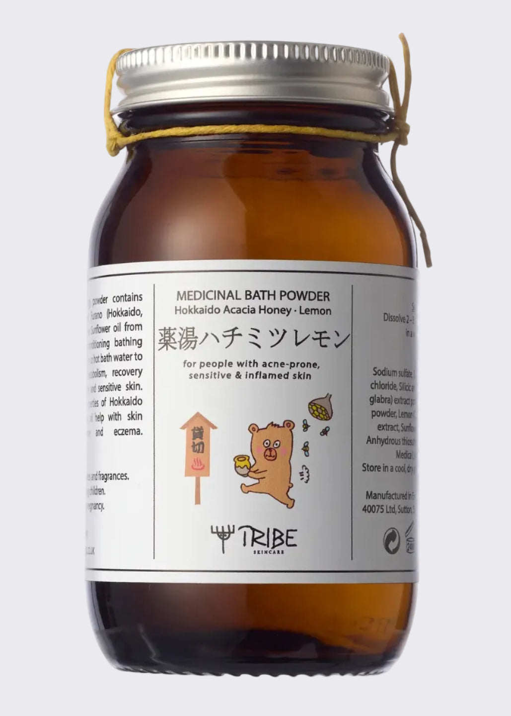 An amber glass jar of TRIBE (Hokkaido Acacia Honey - Lemon) with a silver metal lid and a small twine bow, shown on a white background.