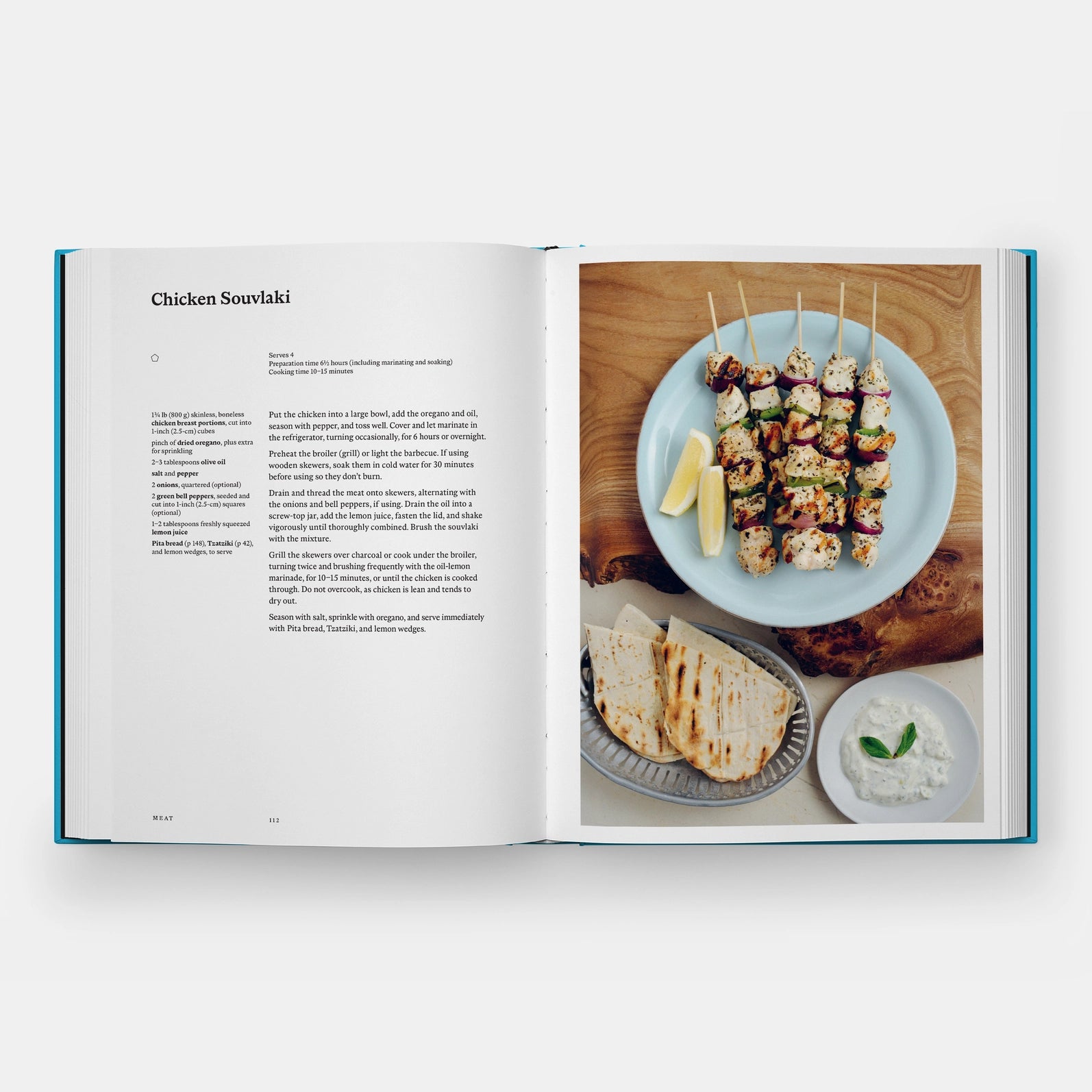 Open cookbook showing a recipe for Chicken Souvlaki with a photo of the dish on a plate.