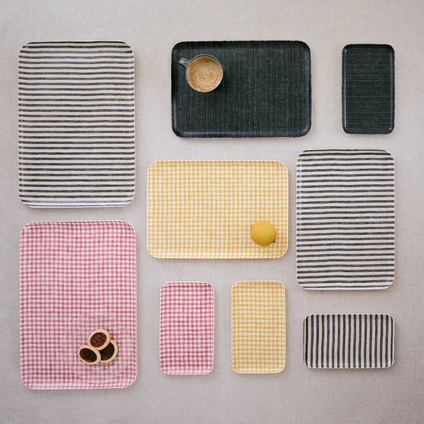Collection of rectangular trays with different patterns on a gray surface
