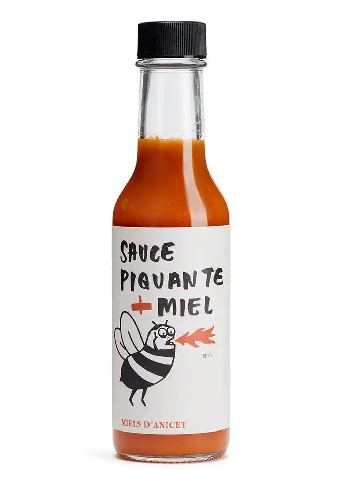 glass bottle with red sauce and drawing of a bee with fire coming out of it's mouth and words, "sauce piquante + Miel" and "miels d'anicet