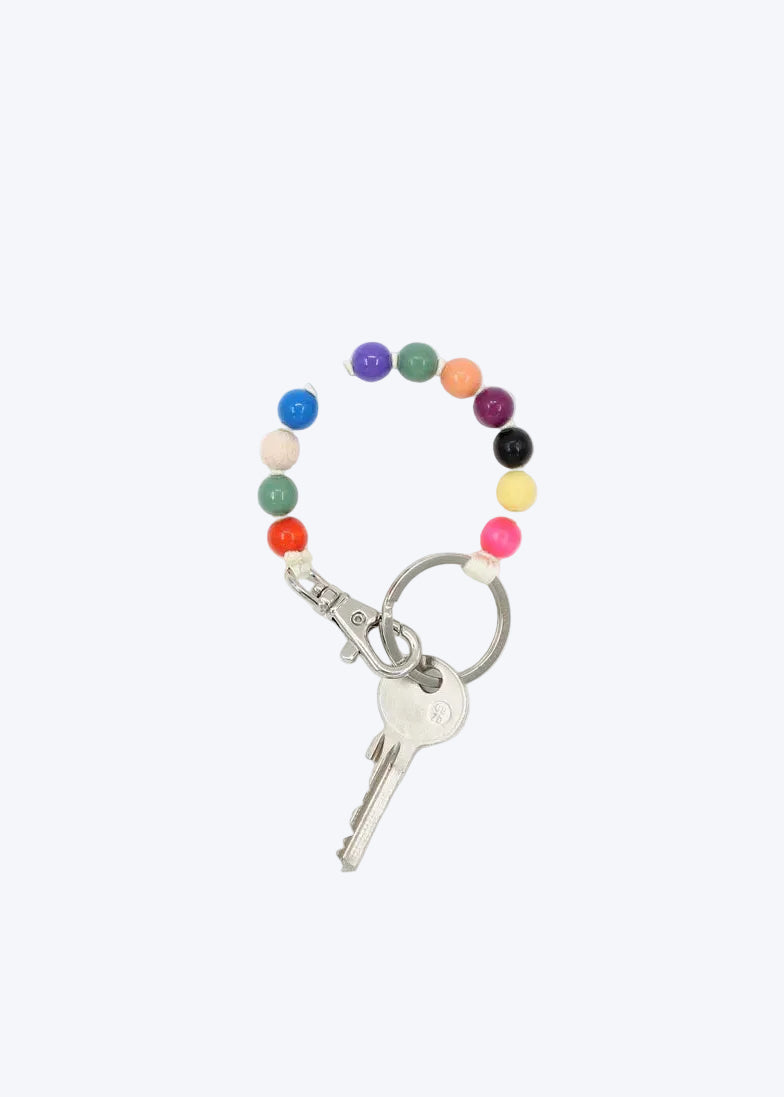 Keychain with colorful beads and a key on a white background