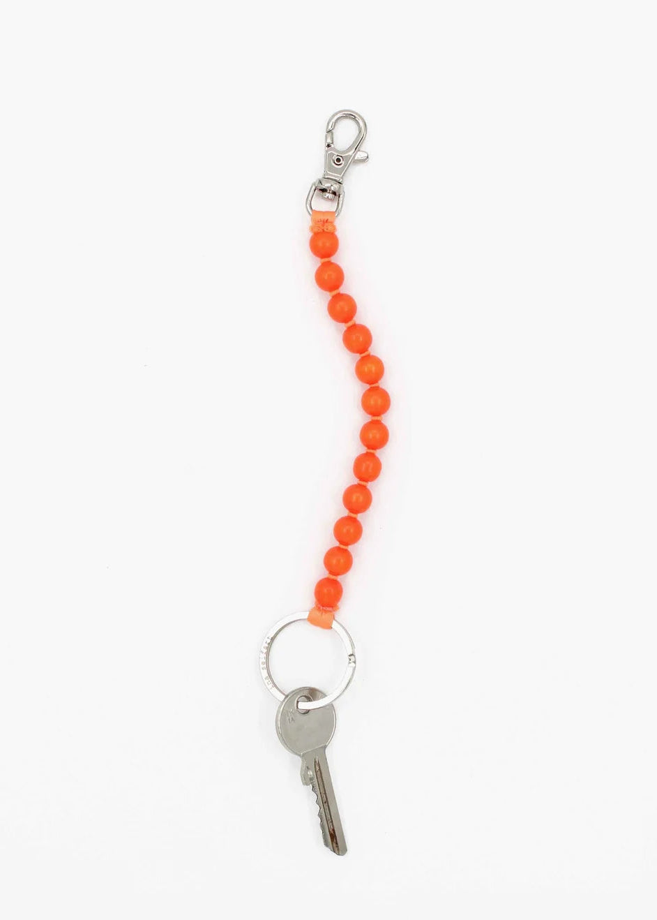 Keychain with orange beads and a key on a white background