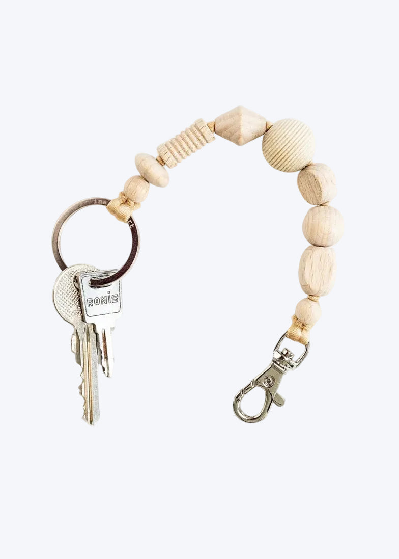 Keychain with wooden beads and keys on a white background